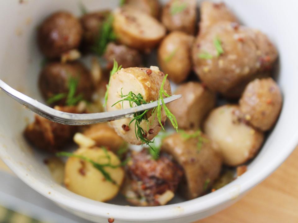 finished potato salad in a bowl with dill