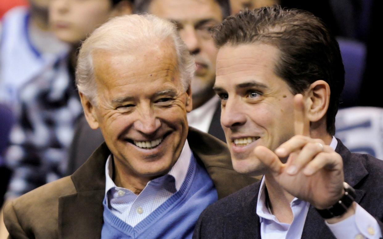 Hunter Biden with his father, Joe Biden, at a basketball game in 2010 - Reuters