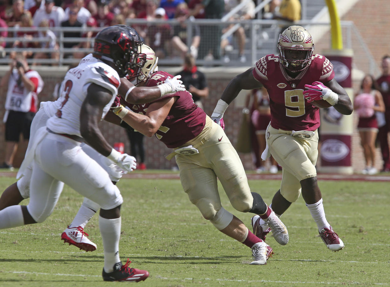 Florida State’s Jacques Patrick (R) rushed for 70 yards in the loss to Louisville. (AP Photo/Steve Cannon)