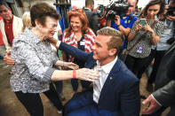 Rep. Madison Cawthorn, R-N.C., embraces supporters at his primary election night watch party in Hendersonville, N.C., Tuesday, May 17, 2022. (AP Photo/Nell Redmond)