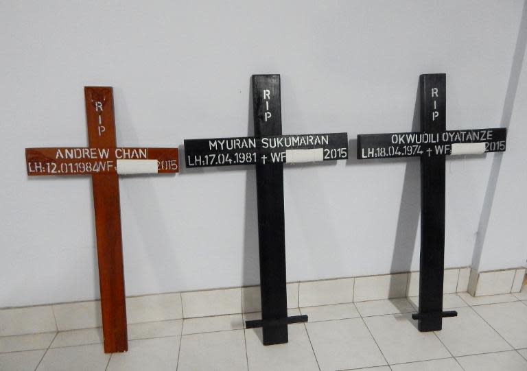 Crosses for condemned drug convicts (L-R) Australians Andrew Chan and Myuran Sukumaran, and Nigerian Okwudili Oyatanze are seen at a church in Cilacap on April 28, 2015, ahead of convicts' imminent execution