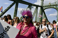 People march across the Szabadsag, or Freedom Bridge over the River Danube in downtown Budapest during a gay pride parade in Budapest, Hungary, Saturday, July 24, 2021. Rising anger over policies of Hungary's right-wing government filled the streets of the country's capital on Saturday as thousands of LGBT activists and supporters marched in the city's Pride parade. (AP Photo/Anna Szilagyi)