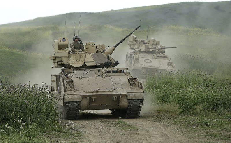 U.S. servicemen drive Bradley infantry fighting vehicles during the joint U.S.-Georgian exercise Noble Partner 2015 at the Vaziani training area outside Tbilisi