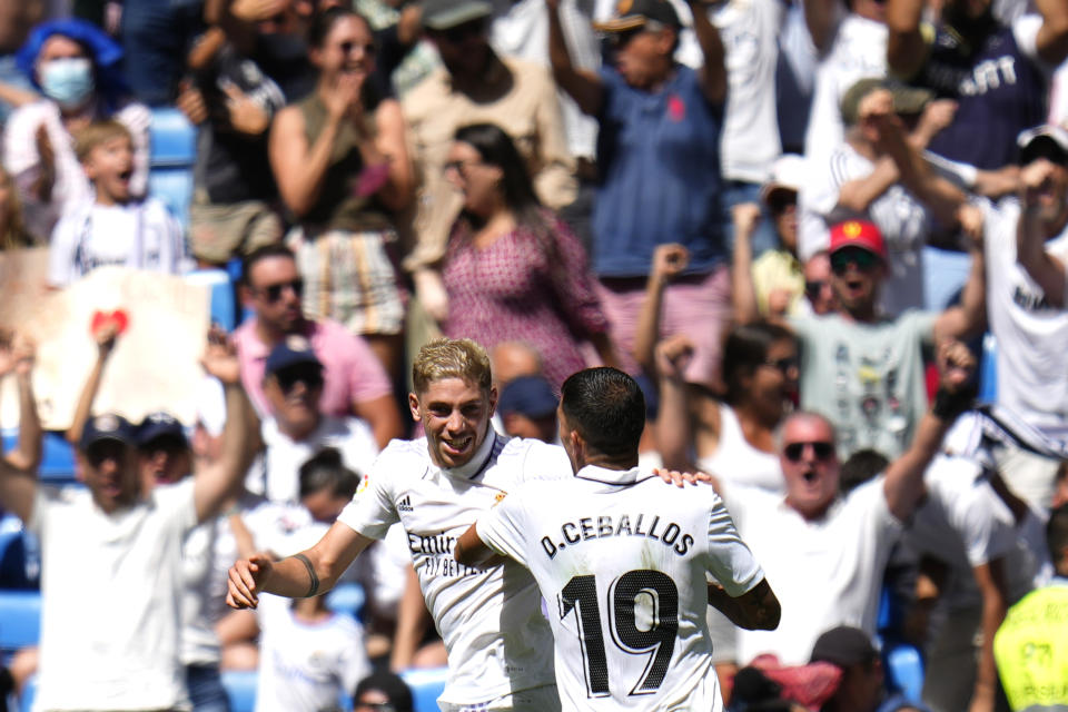 Real Madrid's Federico Valverde, left, celebrates with Real Madrid's Dani Ceballos after scoring his side's first goal during the Spanish La Liga soccer match between Real Madrid and Mallorca at the Santiago Bernabeu stadium in Madrid, Spain, Sunday, Sept. 11, 2022. (AP Photo/Manu Fernandez)