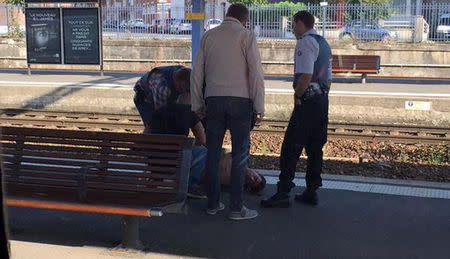 French police stand over a man who is apprehended on the platform at the Arras train station after after shots were fired on the Amsterdam to Paris Thalys high-speed train where several people were injured in Arras, France, August 21, 2015, according to the French interior ministry. REUTERS/Christina Cathleen Coons/Handout via Reuters