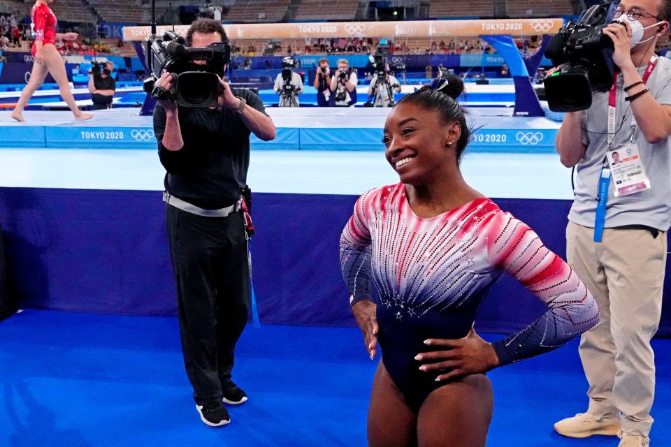 Simone Biles smiles after competing on the balance beam.