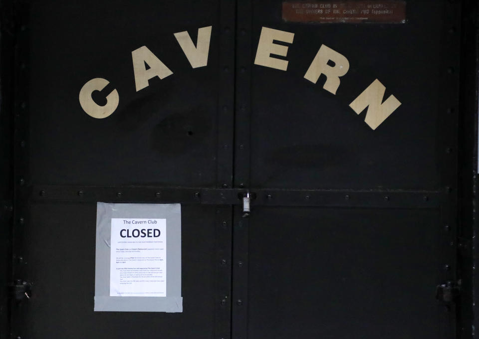 The doors of the famous Cavern bar remain shut as new measures across the region are set to come into force in Liverpool, England, Wednesday, Oct. 14, 2020. New plans unveiled this week show Liverpool is in the highest-risk category, and its pubs, gyms and betting shops have been shut.(AP Photo/Frank Augstein)