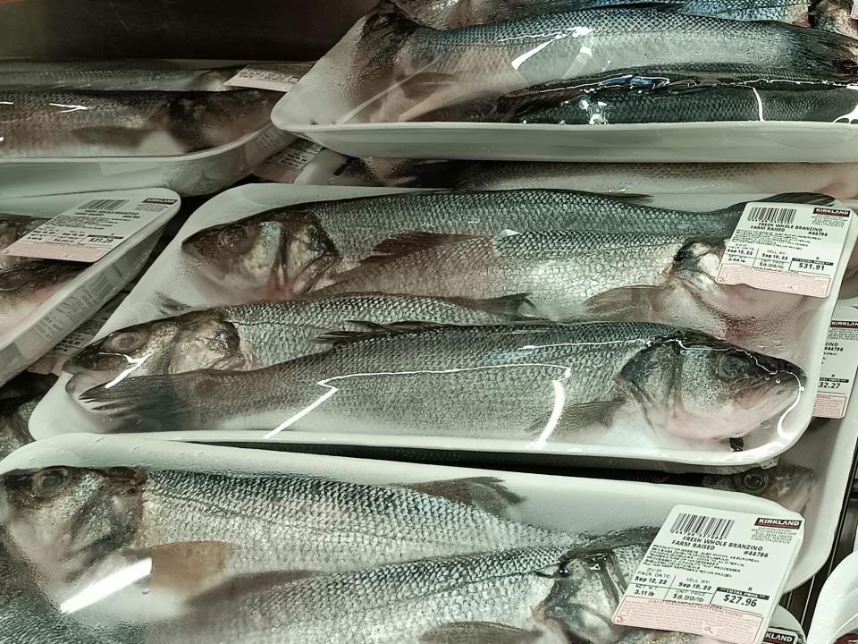 White and clear packages of whole fish at costco