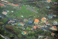 Damaged homes from Hurricane Maria are shown in this aerial photo over the island of Dominica, September 19, 2017. Photo taken September 19, 2017. Courtesy Nigel R. Browne/Caribbean Emergency Management Agency/Regional Security System/Handout via REUTERS