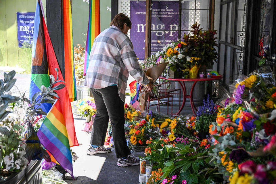 Image: A resident leaves flowers at a makeshift memorial outside the Mag.Pi clothing store in Cedar Glen, near Lake Arrowhead, Calif., on Aug. 21, 2023.  (Robyn Beck / AFP - Getty Images)