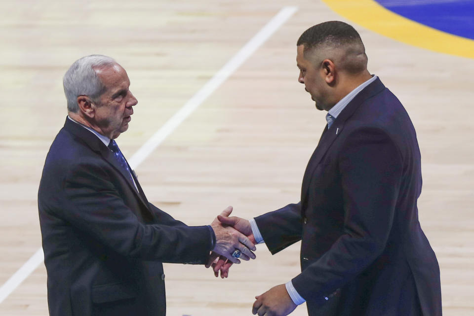 Pittsburgh head coach Jeff Capel, right, shakes hands with North Carolina head coach Roy Williams after an NCAA college basketball game, Saturday, Jan. 18, 2020, in Pittsburgh. Pittsburgh won 66-52. (AP Photo/Keith Srakocic)