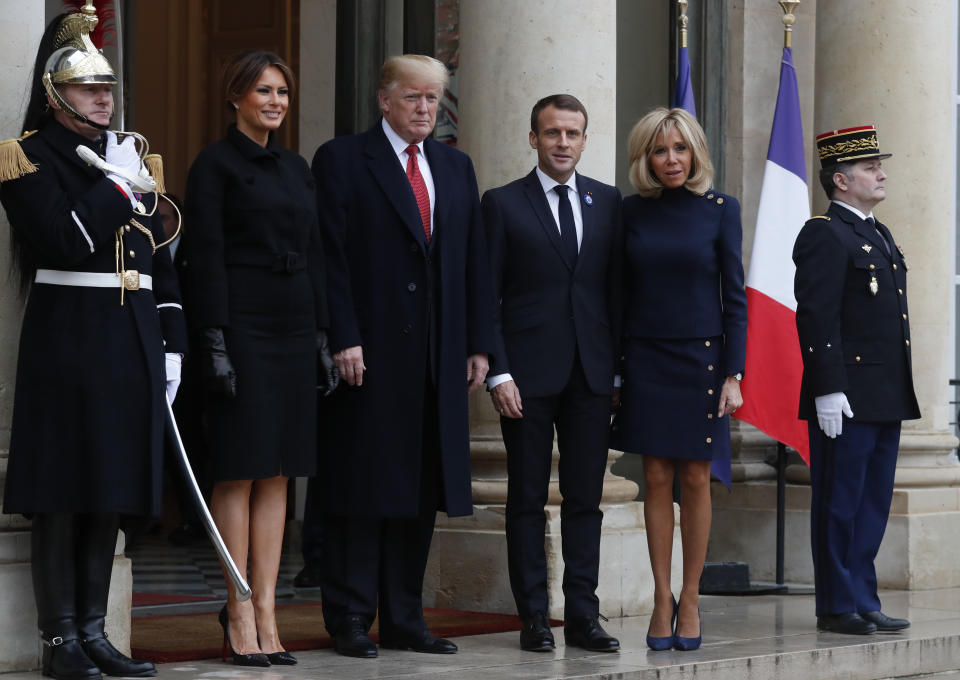 French President Emmanuel Macron, third right, his wife Brigitte, U.S President Donald Trump, and first lady Melania Trump, second left, pose outside the Elysee Palace after their talks and lunch in Paris, Saturday, Nov.10, 2018. Trump is joining other world leaders at centennial commemorations in Paris this weekend to mark the end of World War I. (AP Photo/Thibault Camus)