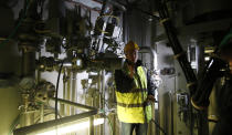 Chief engineer Alessandro Soru speaks to the Associated Press in an undersea tunnel, part of a barrier project to protect Venice from high tides, in Venice, Italy, Friday, Nov. 29, 2019. The barrier system is made up of 78 giant flood gates, each 20 meters long which are attached by hinges to giant cement blocks placed on the seabed along the three openings from the sea into the lagoon, Malamocco, Chioggia and the Lido. (AP Photo/Antonio Calanni)