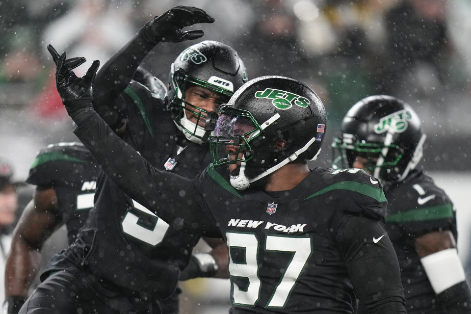 New York Jets linebacker Kwon Alexander (9) celebrates with defensive tackle Nathan Shepherd (97) after a defensive play against the Jacksonville Jaguars during the second quarter of an NFL football game, Thursday, Dec. 22, 2022, in East Rutherford, N.J. (AP Photo/Seth Wenig)