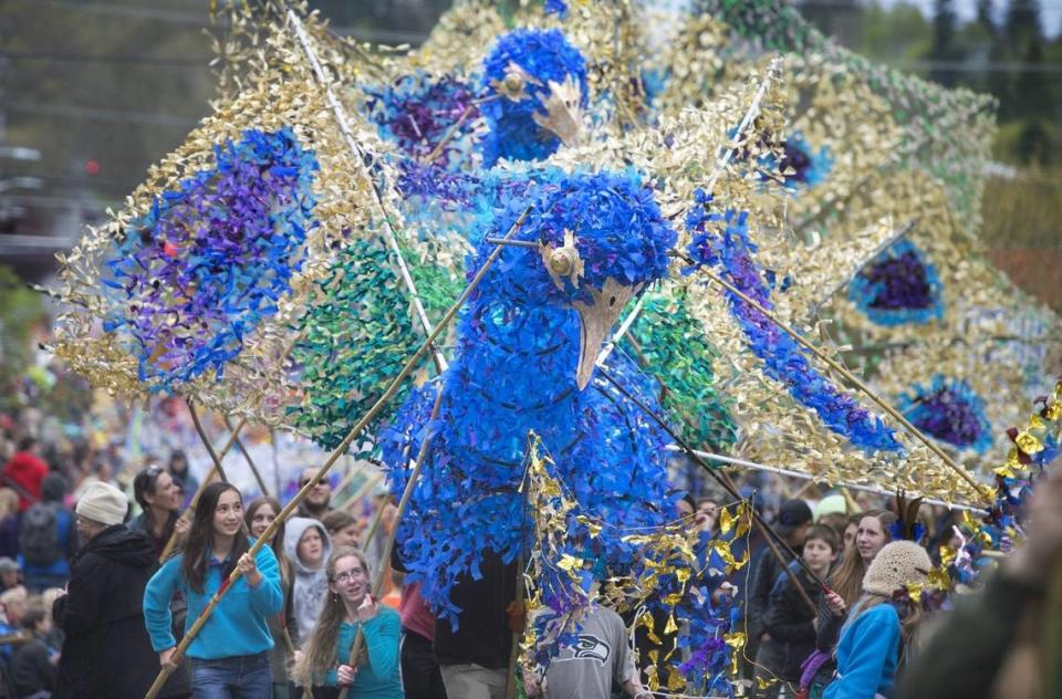 A trio of 20-foot-tall peacock puppets show their colors during the 2017 Procession of the Species celebration in downtown Olympia.