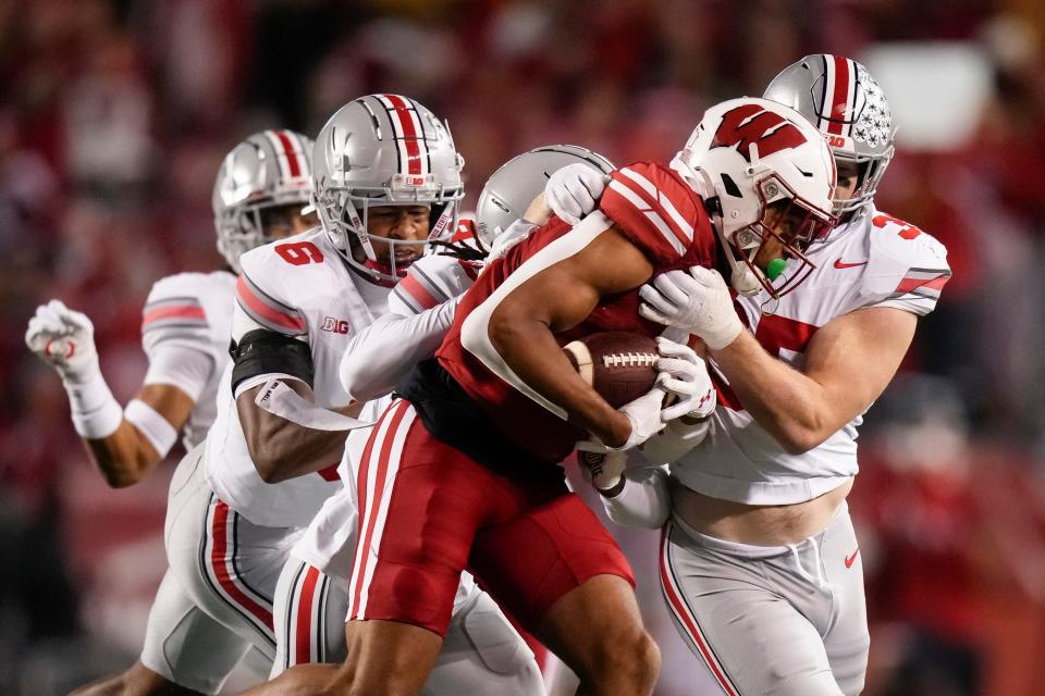 Oct 28, 2023; Madison, Wisconsin, USA; Ohio State Buckeyes linebacker Tommy Eichenberg (35) tackles Wisconsin Badgers wide receiver Bryson Green (9) during the first half of the NCAA football game at Camp Randall Stadium.