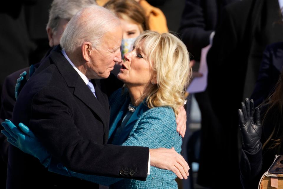 Joe Biden is embraced by first lady Jill Biden after being sworn in as presidentAP