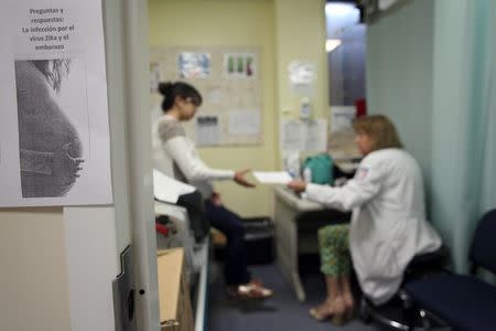 A flyer that reads, "Questions and answers: Zica virus infection during pregnancy" is seen posted outside a doctor's office, at a public hospital in San Juan, Puerto Rico, February 3, 2016. REUTERS/Alvin Baez