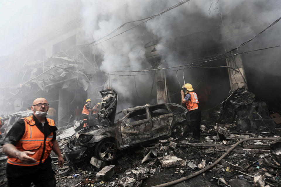 Palestinian rescuers work at the site of Israeli strikes at a refugee camp in the northern Gaza Strip on Monday. (Mahmoud Issa/Reuters)