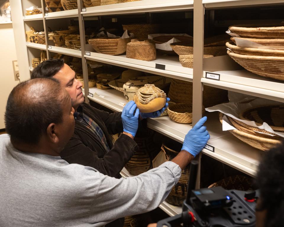 Terrol Dew Johnson and University of Arizona archaeologist Ed Jolie examines some O'odham baskets at the Arizona State Museum archive on Feb. 2, 2023.