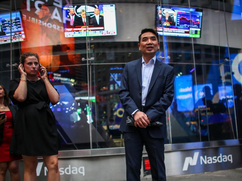 Zoom founder Eric Yuan poses in front of the Nasdaq building as the screen shows the logo of the video-conferencing software company Zoom after the opening bell ceremony on in 2019 in New York City.