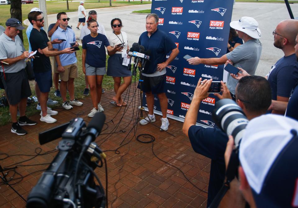 Head coach Bill Belichick speaks to the media on Wednesday in front of a makeshift New England Patriots backdrop at the Rinker Athletic Complex in West Palm Beach.