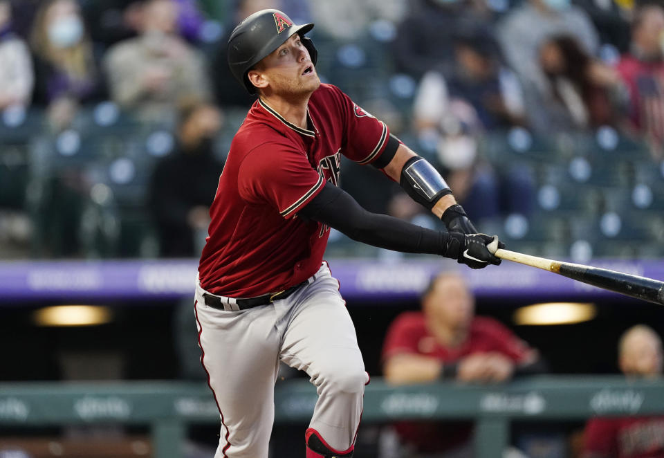 Arizona Diamondbacks' Carson Kelly watches his double off Colorado Rockies starting pitcher Antonio Senzatela during the third inning of a baseball game Wednesday, April 7, 2021, in Denver. (AP Photo/David Zalubowski)