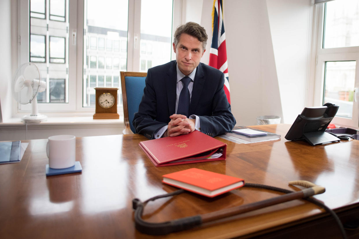 Gavin Williamson sat at his desk, in front of a whip, on 17 August. (Stefan Rousseau/PA)