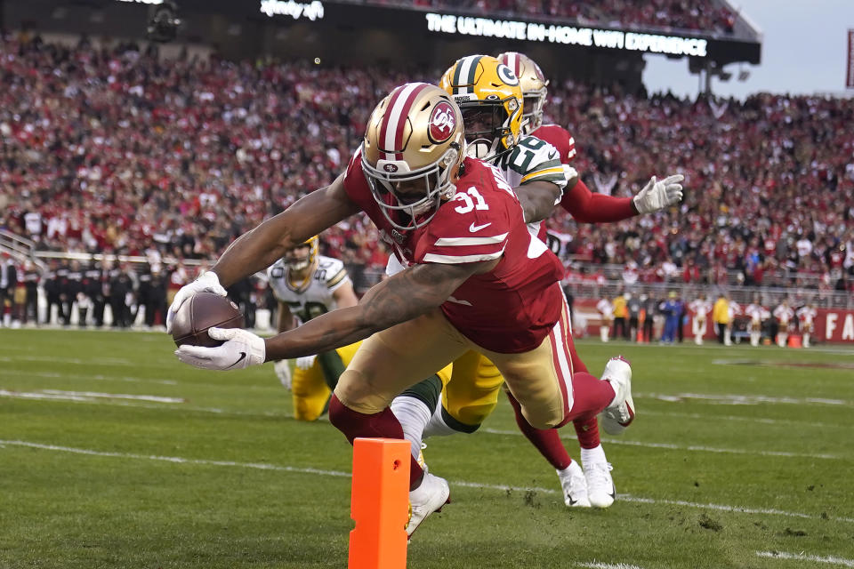 Superman: San Francisco 49ers running back Raheem Mostert leaps for the pylon to score in the second quarter of the NFC title game. (AP/Tony Avelar)