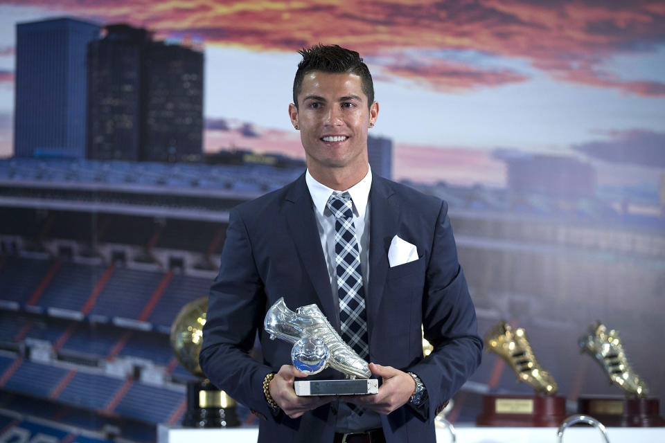 <p>Ronaldo poses for a picture with his trophy as all-time top scorer of of Real Madrid </p>