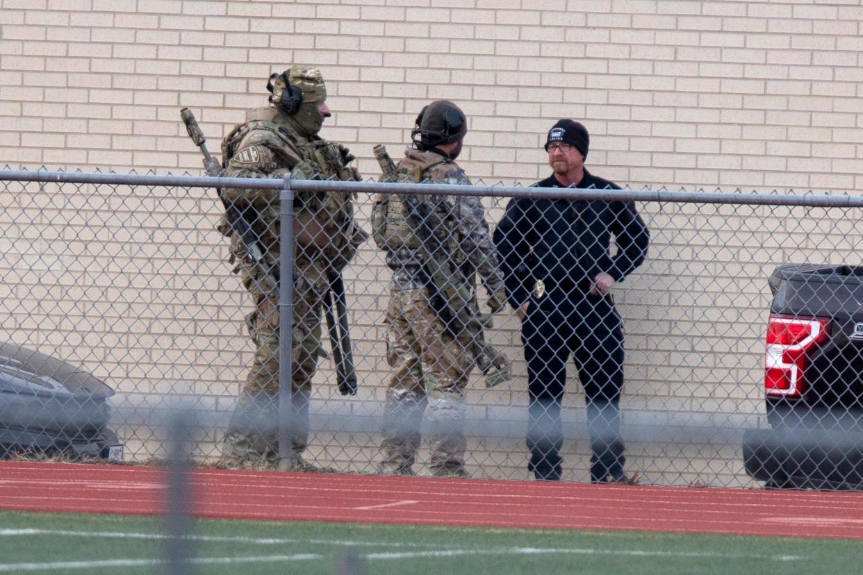 Law enforcement officials gather at a local school near the Congregation Beth Israel synagogue on Jan. 15, 2022, in Colleyville, Texas.