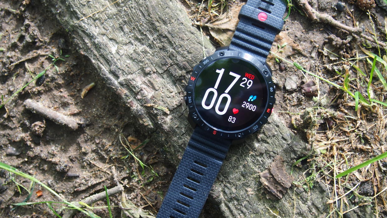  Polar Grit X2 Pro watch on the ground with clock face and step count. 