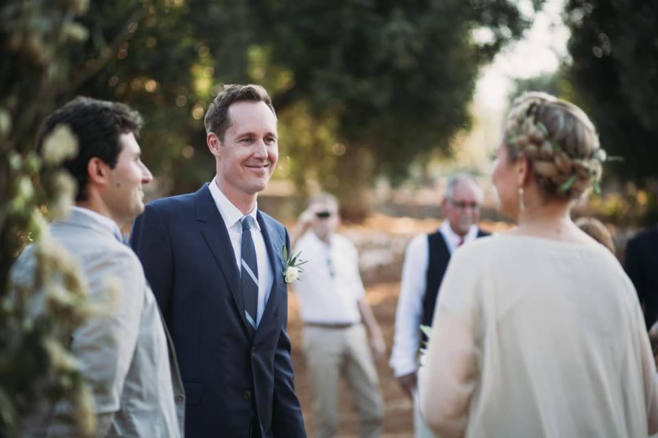 Dylan smiles as his bride recites her vows.