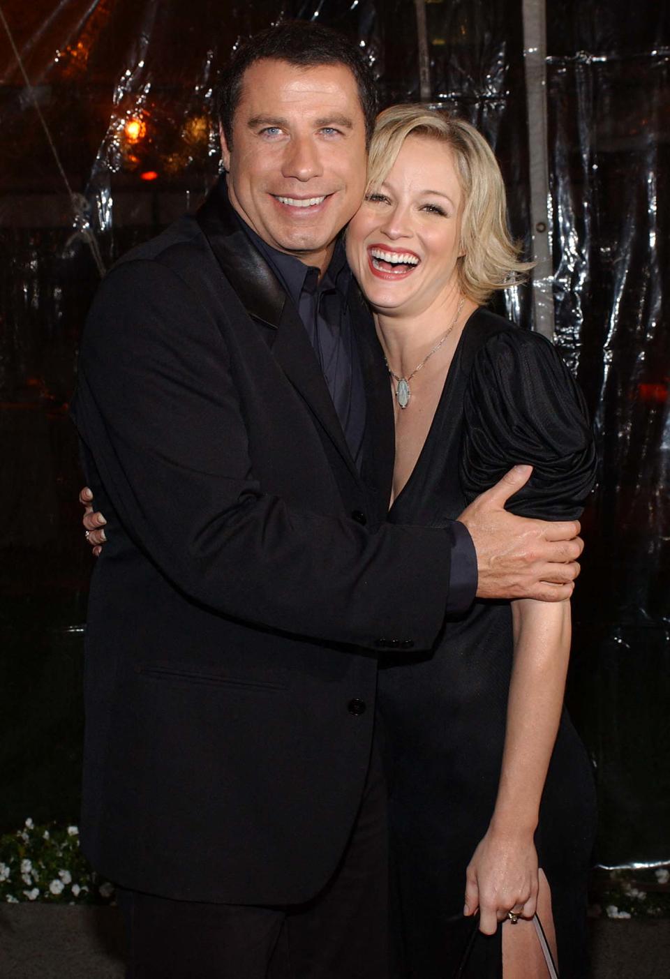 John Travolta and Teri Polo hug at the premiere of their film "Domestic Disturbance" in Hollywood in 2001.