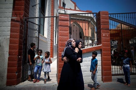 Relatives of Palestinian gunman Mohamad Al-Tramsi mourn during his funeral in the northern Gaza Strip