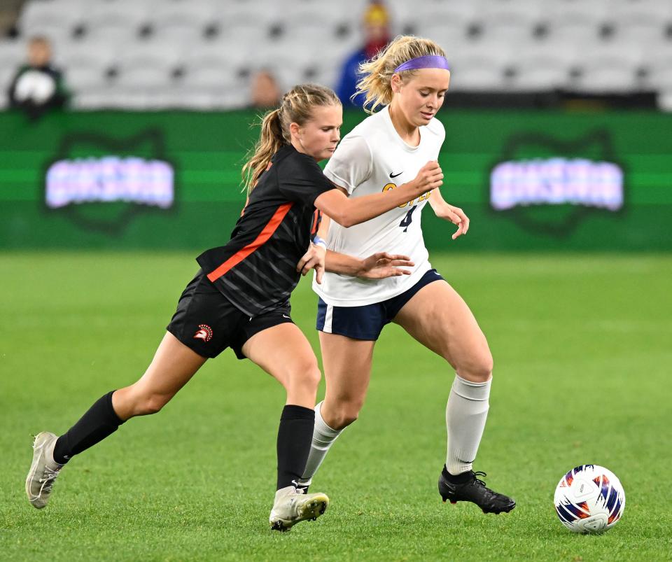 Copley defender Gaby Niemczura, right, takes the ball up the field against Wayneville midfielder Chloe Dunford during the second half of the OHSAA Division II girls state soccer championship game at Lower.com Field, Friday, Nov. 11, 2022, in Columbus, Ohio.