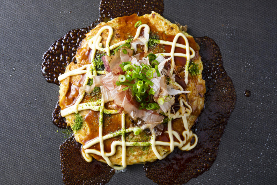 Japanese cabbage pancake drizzled with mayonnaise.