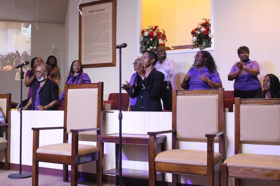 The First Missionary Baptist Church Choir sing during a service Sunday celebrating National Children's Day.