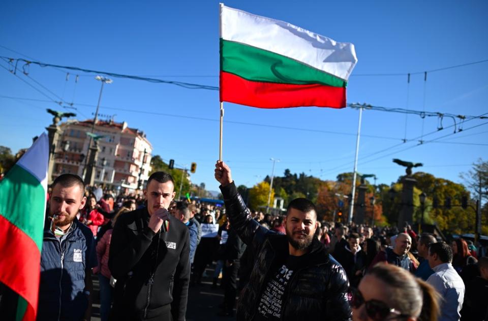 Protesters wave a Bulgarian national flag during a nationwide protest over Covid-19 measures last month (EPA)