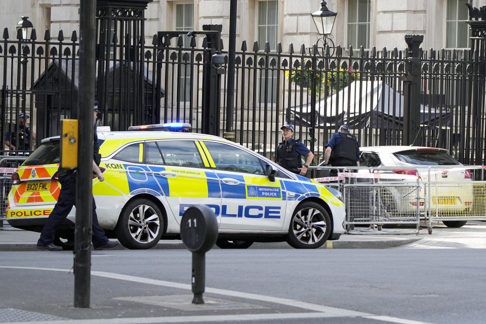 Police at the scene after a car collided with the gates of Downing Street in London in London, Thursday, May 25, 2023. Police say a car has collided with the gates of Downing Street in central London, where the British prime minister's home and offices are located. The Metropolitan Police force says there are no reports of injuries. Police said a man was arrested at the scene on suspicion of criminal damage and dangerous driving. It was not immediately clear whether the crash was deliberate. (AP Photo/Alastair Grant)