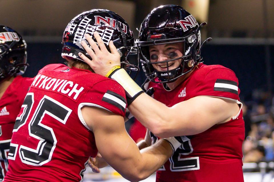 Dec 4, 2021; Detroit, MI, USA; Northern Illinois Huskies quarterback Rocky Lombardi (12) celebrates with running back Clint Ratkovich (25) after scoring a touchdown during the second quarter of the MAC Championship Game against the Kent State Golden Flashes at Ford Field. Mandatory Credit: Raj Mehta-USA TODAY Sports