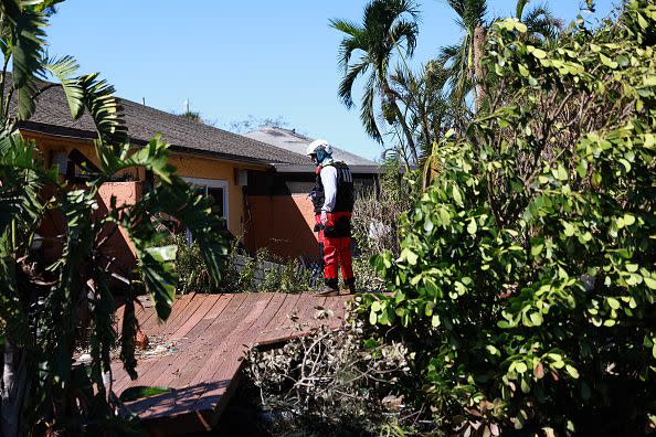 FORT MYERS, FLORIDA - SEPTEMBER 30: A member of the Texas A&M Task Force 1 Search and Rescue team looks for anyone needing help after Hurricane Ian passed through the area on September 30, 2022 in Fort Myers, Florida.  The hurricane brought high winds, storm surges and rain to the area causing severe damage. (Photo by Joe Raedle/Getty Images)