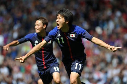 Japan's Kensuke Nagai (R) celebrates scoring during the London 2012 Olympic men's football quarter final match between Japan and Egypt at Old Trafford in Manchester, north-west England. Japan won 3-0