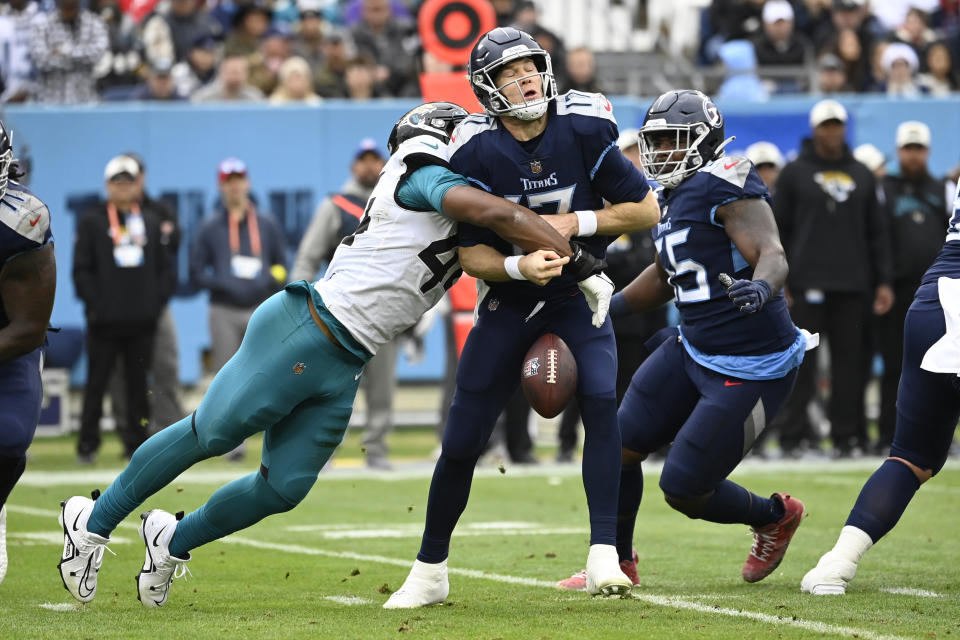 Tennessee Titans quarterback Ryan Tannehill (17) fumbles as he is sacked by Jacksonville Jaguars linebacker Travon Walker during the first half of an NFL football game Sunday, Dec. 11, 2022, in Nashville, Tenn. The Jaguars recovered the fumble. (AP Photo/Mark Zaleski)