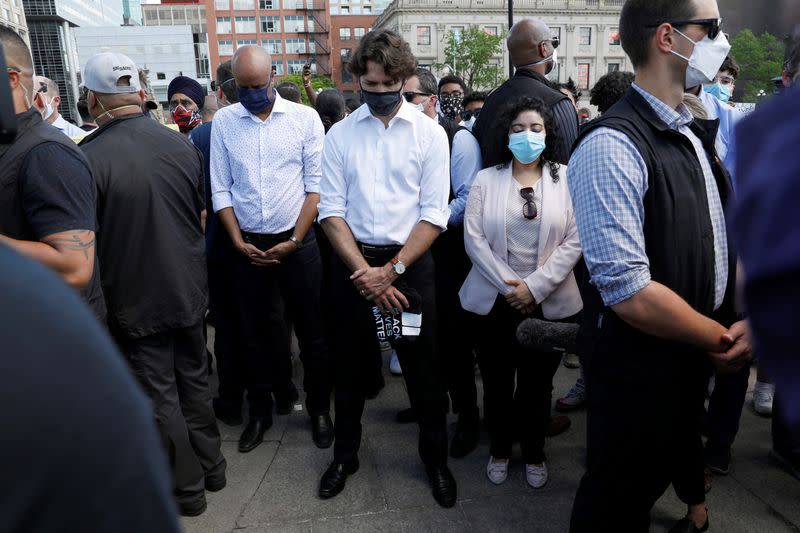 Canada's Prime Minister Justin Trudeau wears a mask as he takes part in a rally against the death in Minneapolis police custody of George Floyd, on Parliament Hill, in Ottawa