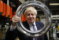 Britain's Prime Minister Boris Johnson holds part of the door of a washing machine at Ebac electrical appliances manufacturer during a General Election campaign trail stop in Newton Aycliffe, England, Wednesday, Nov. 20, 2019. Britain goes to the polls on Dec. 12. (AP Photo/Frank Augstein, Pool)