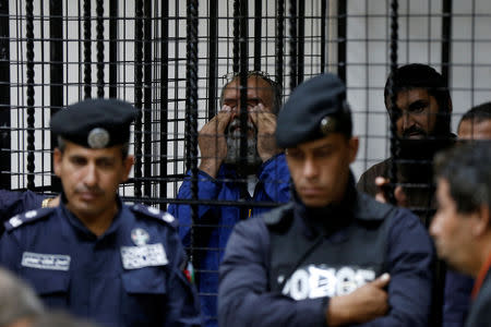 A prisoner cries out of happiness, after he was proven not guilty, during the trial of those accused in staging an attack on December 2016 on a Crusader castle in Kerak, at the State Security Court in Amman, Jordan November 13, 2018. REUTERS/Muhammad Hamed