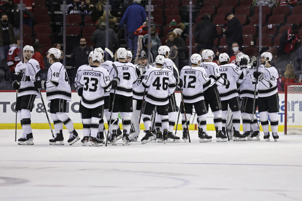 The Los Angeles Kings celebrate after defeating the New Jersey Devils in an NHL hockey game Sunday, Jan. 23, 2022, in Newark, N.J. (AP Photo/Adam Hunger)