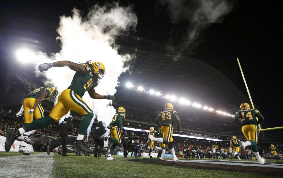 Members of the Edmonton Eskimos run onto the field prior to the CFL's 103rd Grey Cup championship football game against the Ottawa Redblacks in Winnipeg, Manitoba, November 29, 2015. REUTERS/Mark Blinch