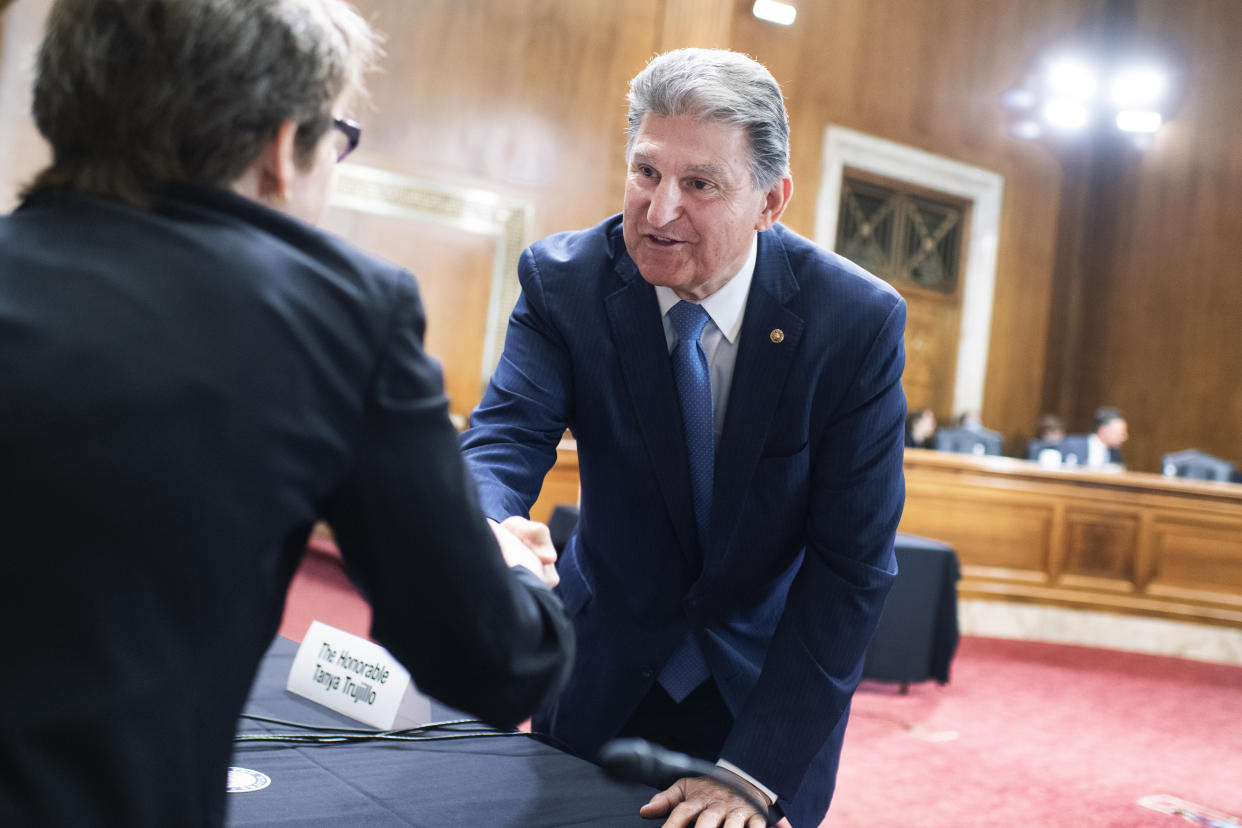 Sen. Joe Manchin, D-W.Va., greets Dr. Kathleen Hogan, acting undersecretary for science and energy on June 24. (Tom Williams/CQ-Roll Call, Inc. via Getty Images)